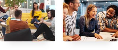 A group of people are in discussion with some seated on the floor and others on couches. 