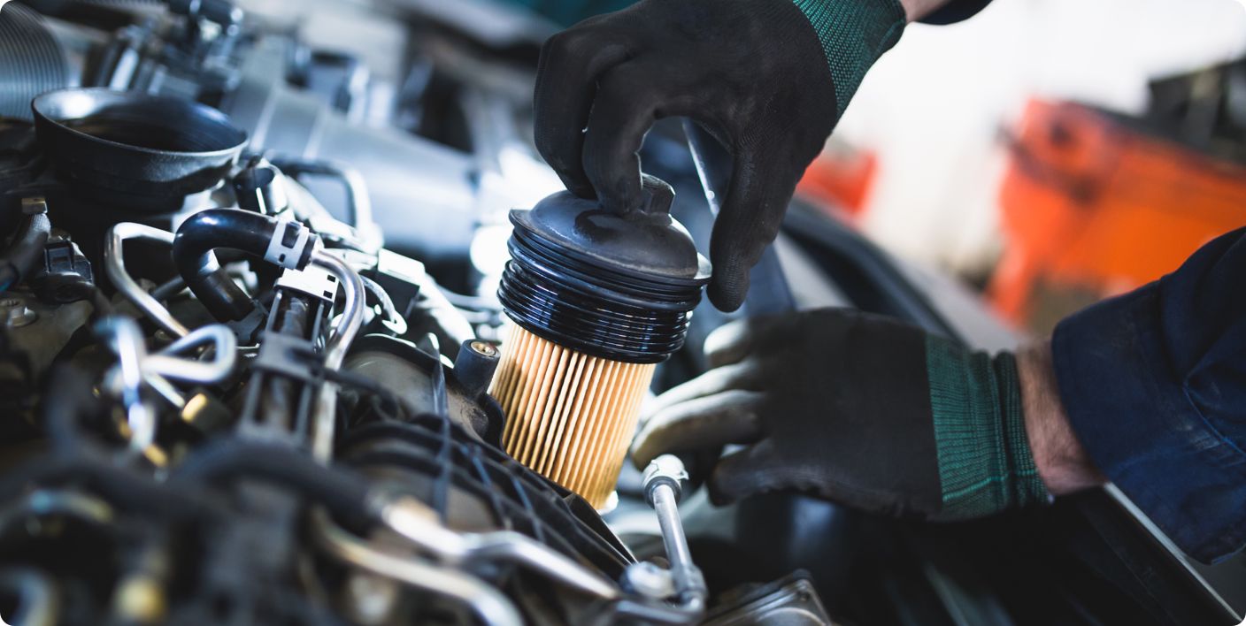 Close up of the insertion of a brand new oil filter into an engine of a car