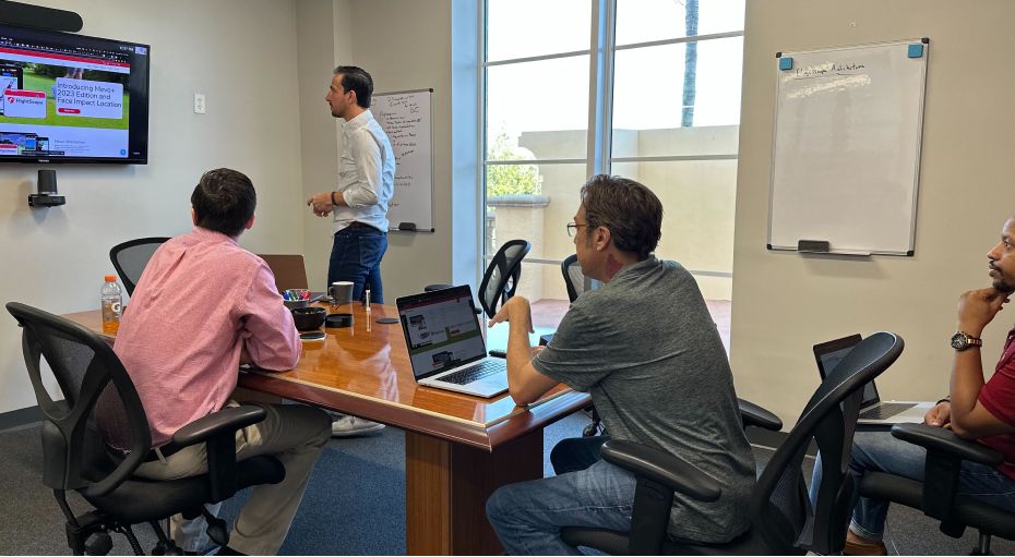 office meeting with participants reviewing a screen share